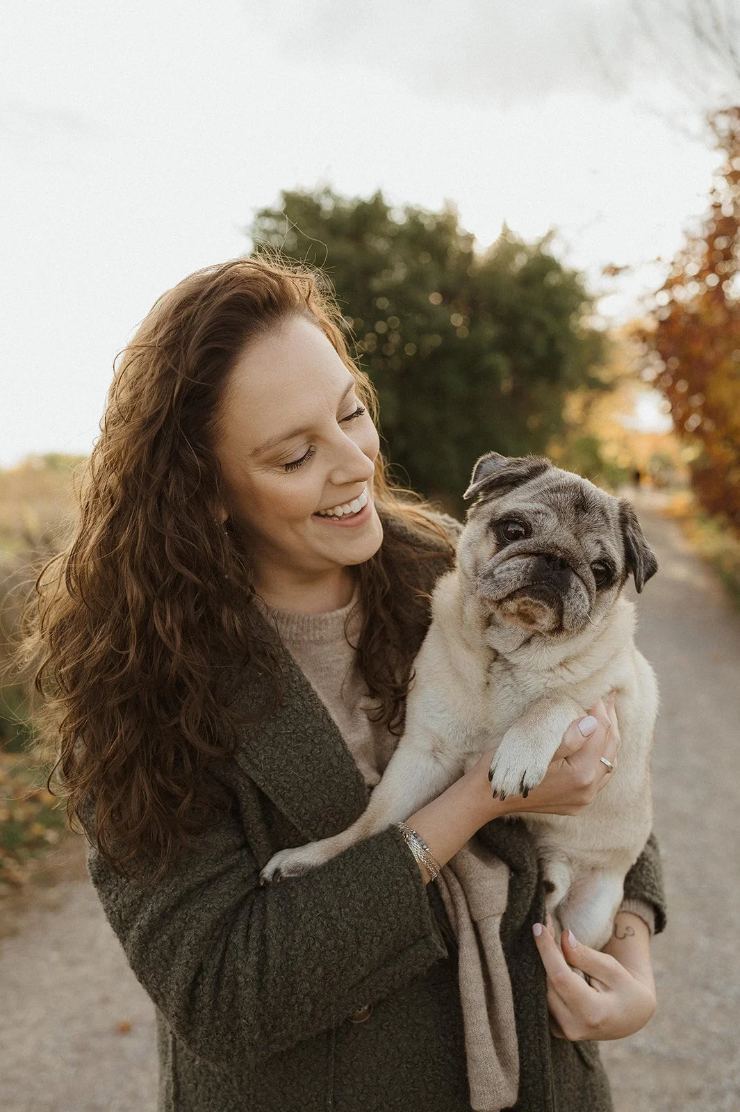 Breana Rutledge holding her pug, smiling