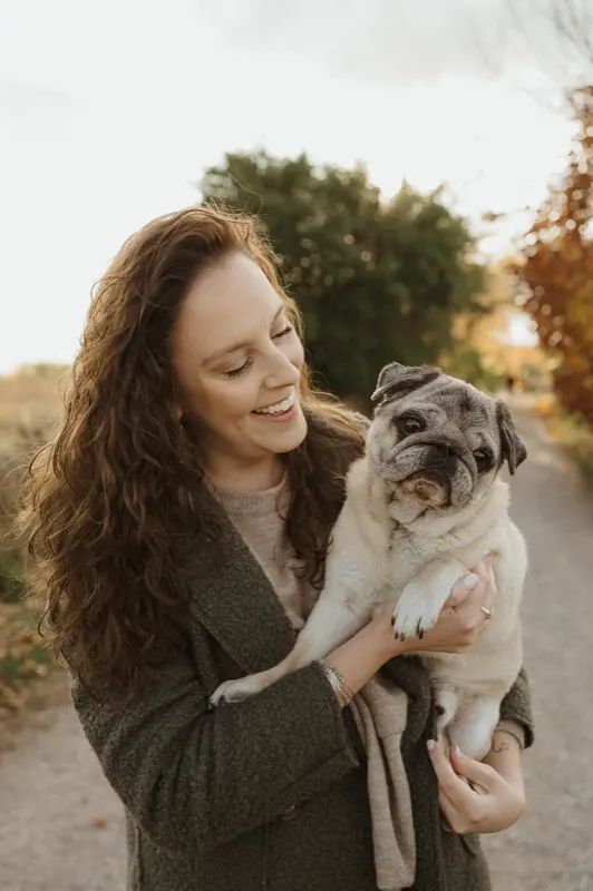 Breana Rutledge holding her pug, smiling